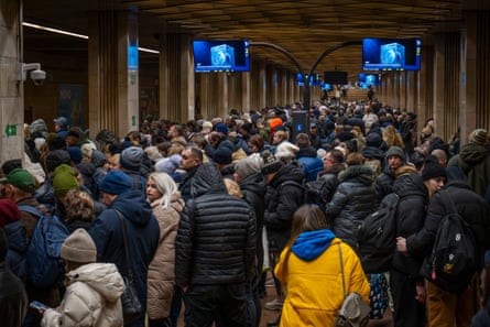 People take cover in a metro station during a Russian drone attack