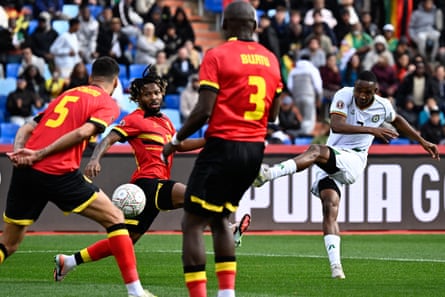 Zimbabwe forward Prince Dube sends a shot at goal against Angola