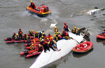 Search and rescue team members operate on a TransAsia Airways passenger plane crashed into the Keelung River in Taipei, Taiwan.