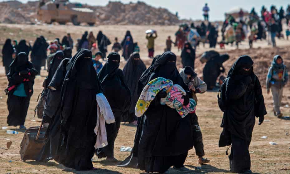 Women and children flee Baghouz in Syria on 12 February after the latest US-backed operation to expel Islamic State. 