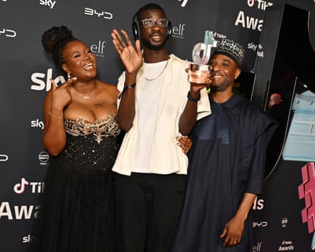 Tola Andu, Kevin Andu and a guest pose for photos