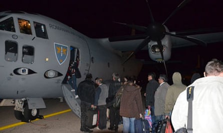 Romanian evacuees board a C-27J Spartan military airplane at Tripoli airport