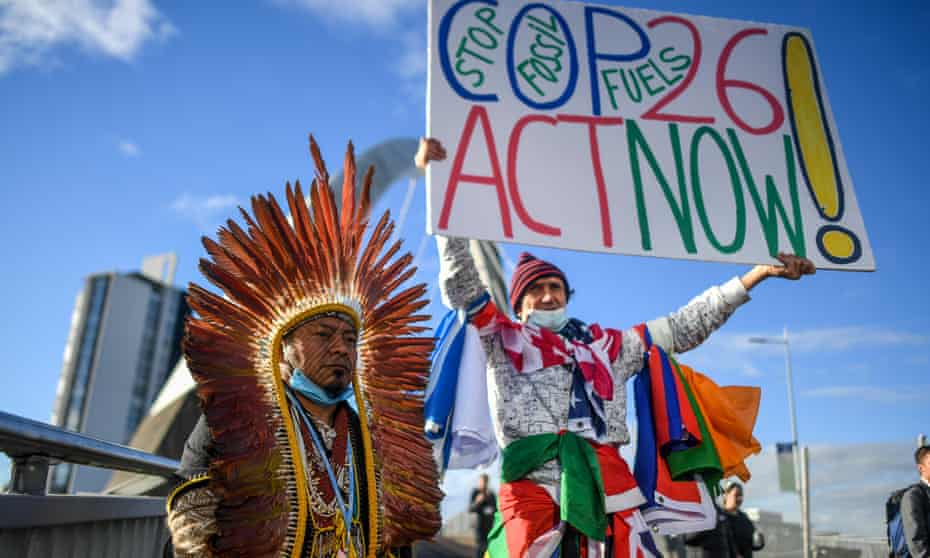 Protester and an indigenous delegate at the Cop26 summit, 3 November 2021.