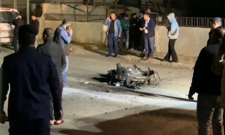 Onlookers and security agents standing around the debris of a missile that the Jordanian forces intercepted over Amman amid an Iranian drone and missile attack on Israel in the early hours of 14 April 2024.