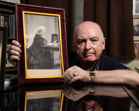 A picture of Andrew Broughton holding a signed photograph of Queen Victoria.