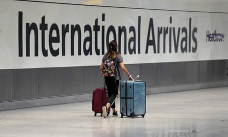 A passenger arrives from a flight at Terminal 5 of Heathrow airport.