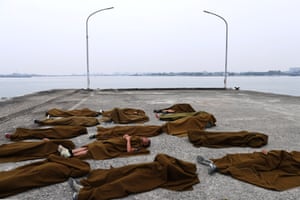 Trainees sleep outside on a rough concrete floor