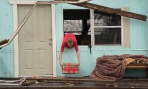 A man removes some possessions from his home in the aftermath of Hurricane Harvey.