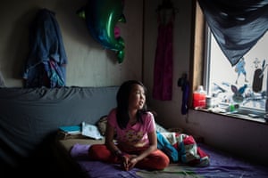 Jasmine Kassaiuli sits in her bedroom in Newtok. Recently the ceiling of her home split as the thawing permafrost continues to destroy the foundation.