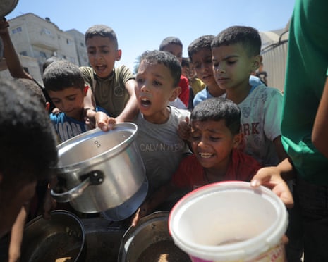 Children gather to receive food aid.