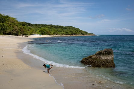 A child plays on the pristine beaches of the Philippines’ Fuga Island, home to about 2,000 people