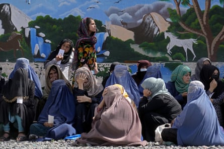 Afghan women wait to receive food rations in April 2022. The following month the Taliban ordered women to cover their faces in public.