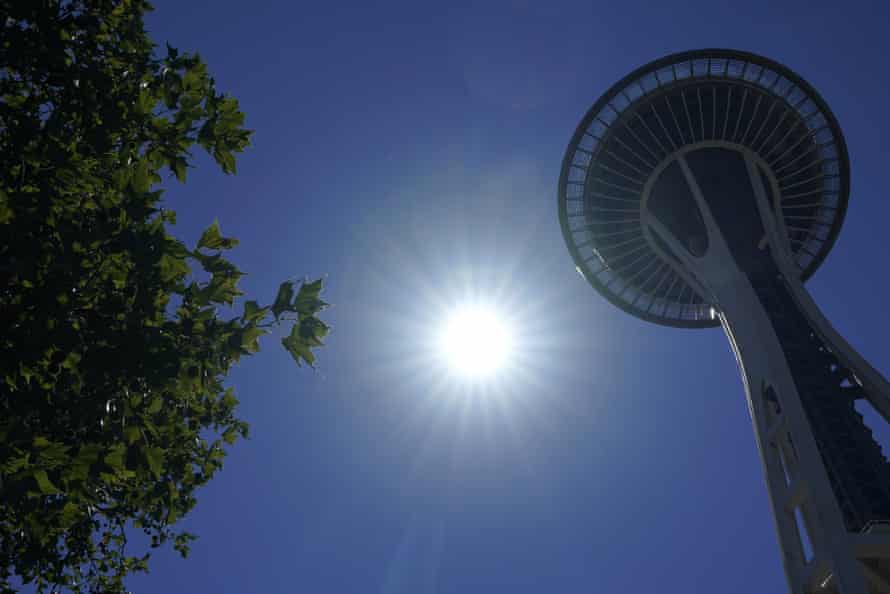 The sun shines near the Space Needle in Seattle in June.