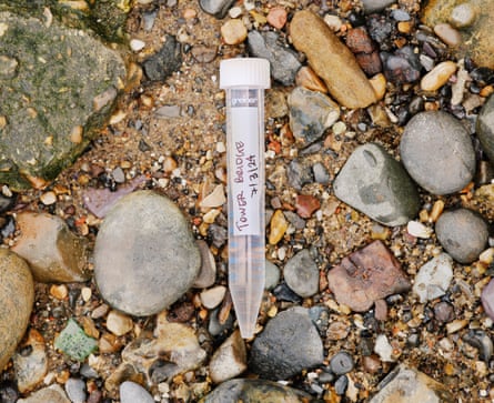 A vial of water labelled as being from Tower Bridge, on the river shore