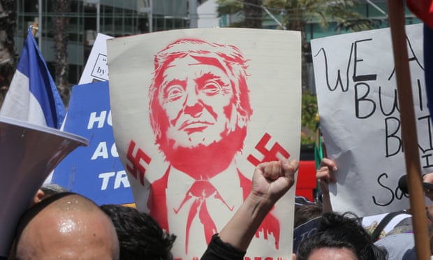 A protest sign with swastikas and Republican nominee Donald Trump, who has drawn sympathisers to the Ku Klux Klan and American Nazi Party.