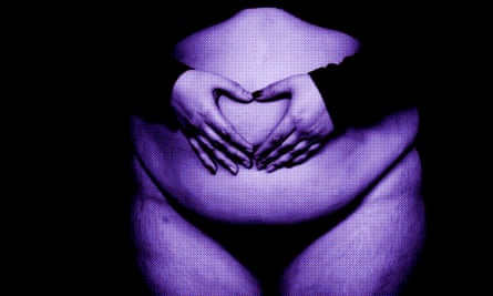 A woman shows a heart with her hands on a fat belly on a black background.