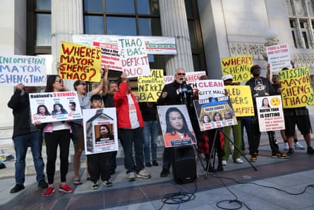 People with signs on steps of building.
