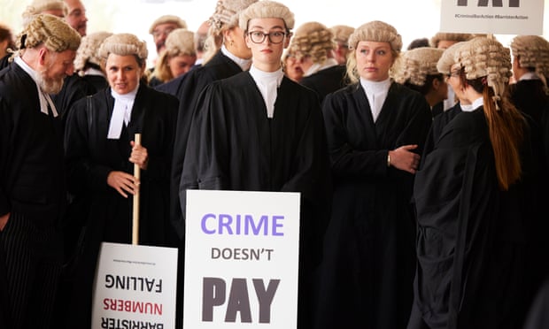 Barristers protest outside Manchester crown courts. Criminal barristers say they can end up being paid less than the minimum wage for court hearings.