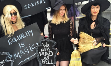 Women dressed as witches with placards reading 'Equality is magic', 'We are mad as hell'.