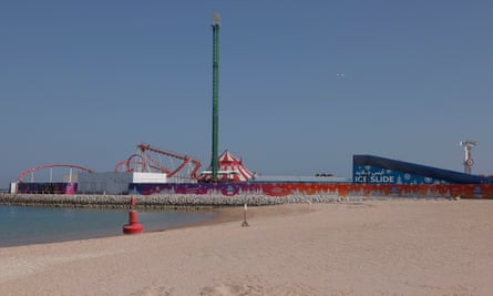 Some of the Winter Wonderland rides are visible including the Ice Slide above the beach on the man-made island of Al Maha