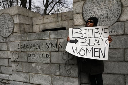 A woman stands beside the empty pedestal where a statue of J Marion Sims was taken down.
