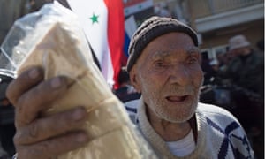 Russian humanitarian aid is handed to a man in Hama, Syria.