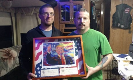 John Beavers, right, was presented with a framed replica of a Trump portrait following the violent clashes in Berkeley, California.