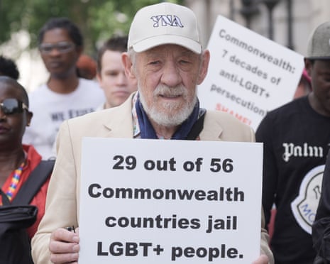 Ian McKellen holding a placard that reads: '29 out of 56 Commonealthh countries jail LGBT+ people'