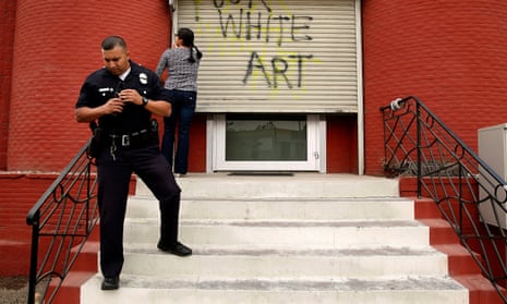 Police respond outside the vandalized art gallery where the words ‘fuck white art’ had been spray painted. 