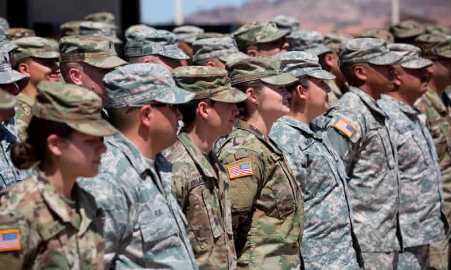 Members of the Arizona national guard listen to instructions in Phoenix. The additional troops would bolster national guard forces already at the border.