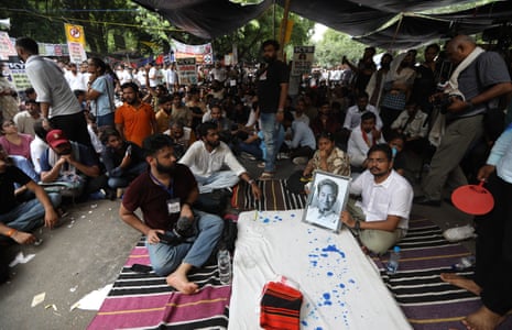 Demonstrators hold a portrait of Wangchuk