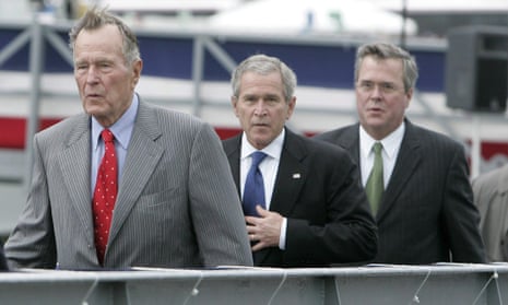 George HW Bush walks with his sons George W Bush and Jeb Bush.