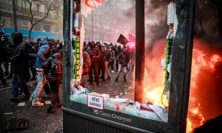 Protesters clash with French riot police during the demonstration against pension reforms in Paris.