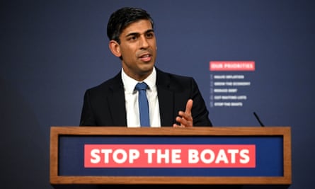 Rishi Sunak gestures as he speaks at a lectern bearing the message: ‘Stop the boats’