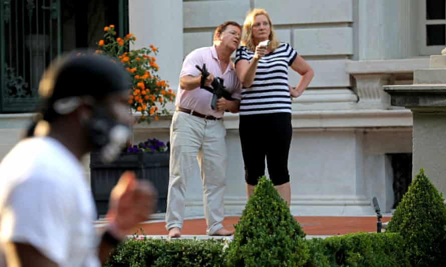 In this June 28, 2020 file photo, Mark and Patricia McCloskey are shown outside their St. Louis mansion with guns after protesters walked onto their private street.