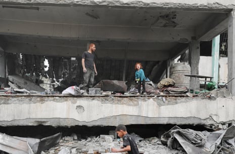 Palestinians inspect the damage at a school sheltering displaced people, following an Israeli strike, in Jabalia refugee camp, in the northern Gaza Strip.