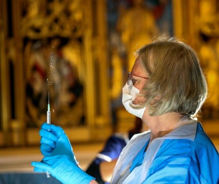 The Pfizer coronavirus vaccine is prepared by a healthcare worker at Salisbury Cathedral, Wiltshire.