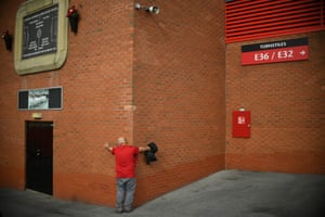 A Manchester United fan embraces the walls of Old Trafford before United’s comprehensive win over Leicester City