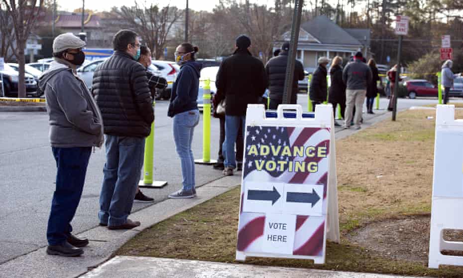 People wait to vote in Georgia’s Senate runoff election in December 2020.
