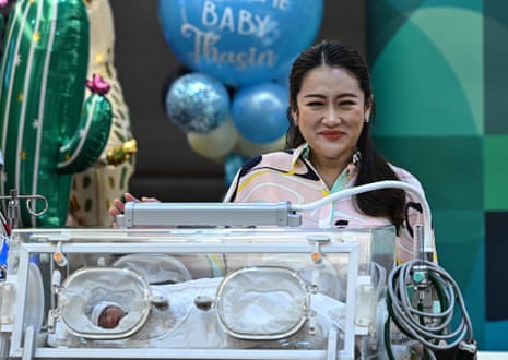 Pheu Thai Party candidate Paetongtarn Shinawatra, presents her newborn son Thasin in an incubator at a press conference in Bangkok on 3 May.