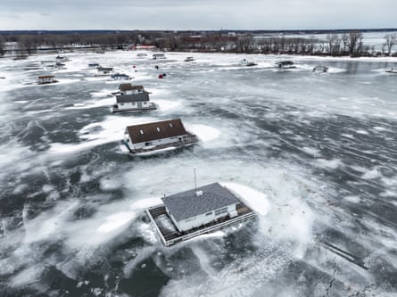 an icy lake with sophisticated shacks on its surface
