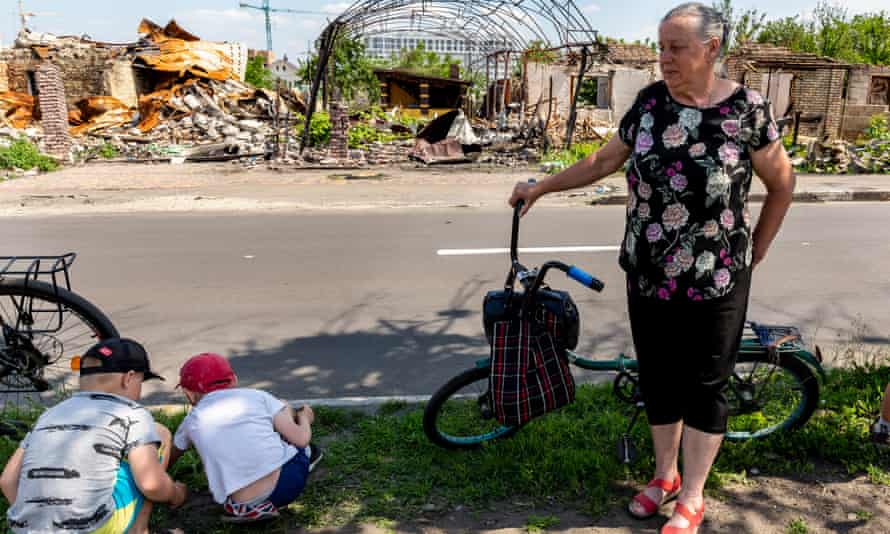 A woman waits for a humanitarian help at bombarded Vokzalna Street.