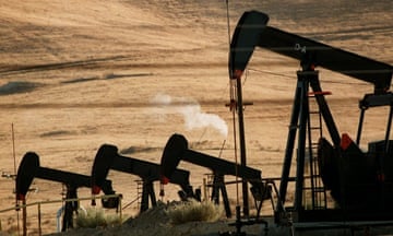 Oil pumps work in an oil field in California