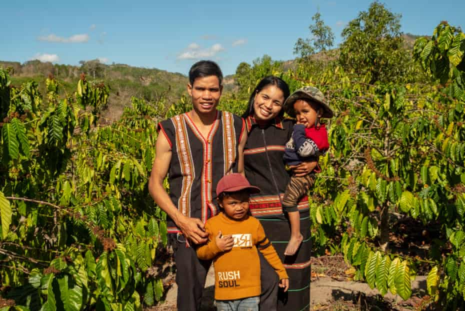 Brothers Khun, 6, and A Khin, 3, with their father, Trun, and mother, Nu, in the family’s coffee field.