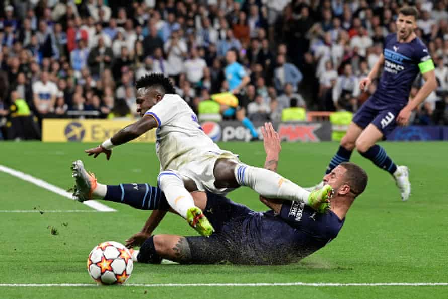 A perfectly timed sliding tackle by Manchester City’s Kyle Walker thwarts Real Madrid’s Vinicius Junior.