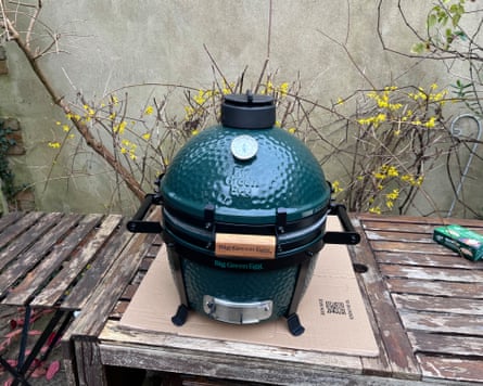 A Big Green Egg unit set up in a garden