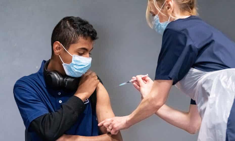 A health worker administers a Pfzier vaccine at Adwick Leisure Centre, in Doncaster.