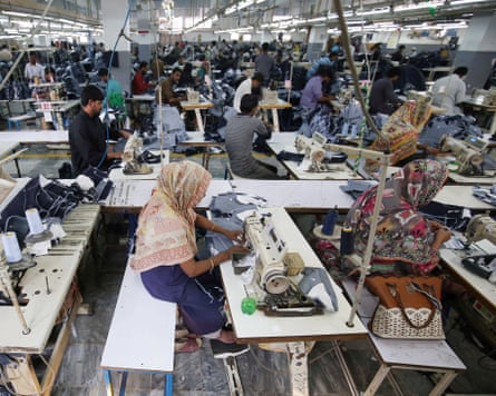 People work at a garments factory in Karachi, Pakistan, 29 November 2019.