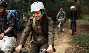 Group of friends ride mountain bike in the forest together