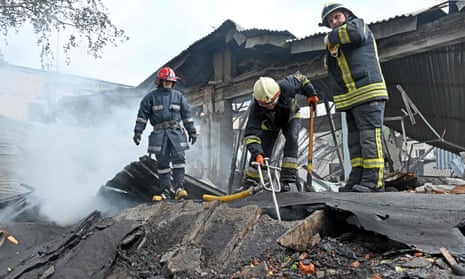 Firefighters put out a fire on the ruins of a destroyed electrical products plant in Kharkiv.